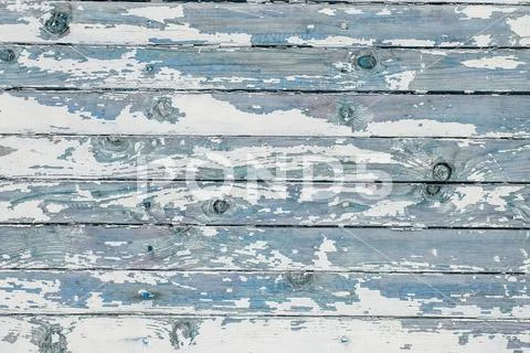 Cracking and peeling white paint on a wall. Vintage wood background with peel Stock Photos