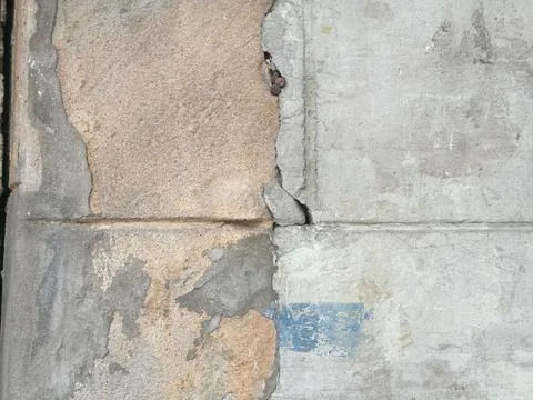 Cracking between light brown and gray cement walls Stock Photos