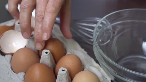Cracking, breaking eggs into a mixing bowl Stock Footage 136491073