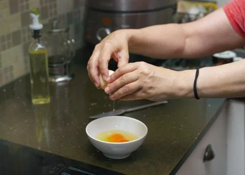 Cracking chicken eggs 写真素材