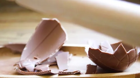 Cracking an Chocoate Easter Egg Stock Footage 333327807