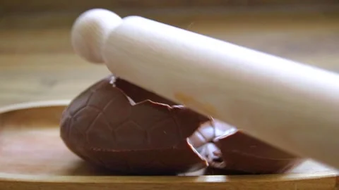 Cracking a Chocolate  Easter Egg Stock Footage 333327423