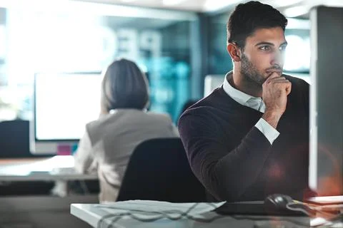 Cracking the code to a new promotion. a young businessman working on his 스톡 사진