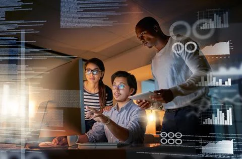 Cracking codes no matter the time. Shot of computer programmers looking throu Stock Photos