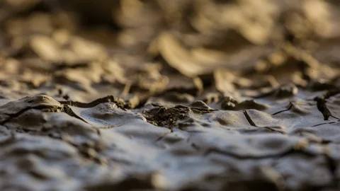 Cracking earth close up mud macro drying wet soil timelapse drought famine Stock Footage 102769236