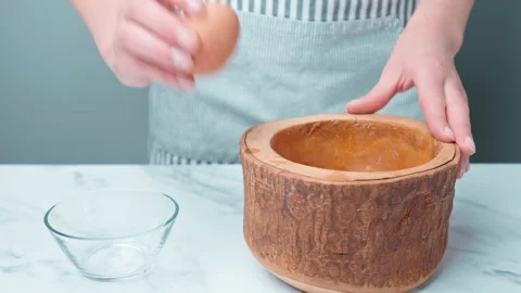 Cracking an Egg and separating the yolk and white in 4k in slow-motion. Stock Footage 140767525