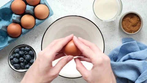 Cracking egg in bowl cooking process Stock Footage 159592794