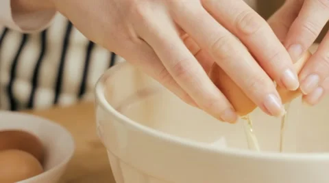 Cracking egg into bowl Stock Footage 10921469
