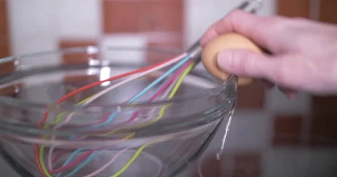 Cracking an Egg Into a Bowl Stock Footage 84830203