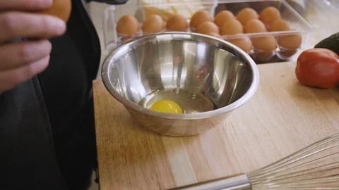 Cracking an egg into a bowl for an omelete Stock Footage 108597631