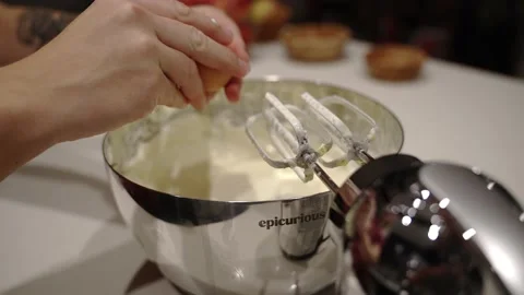 Cracking an egg into cake batter Stock Footage 222166066