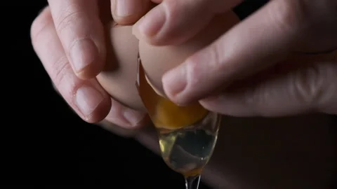 Cracking an egg falling slow motion Stock Footage 169238569