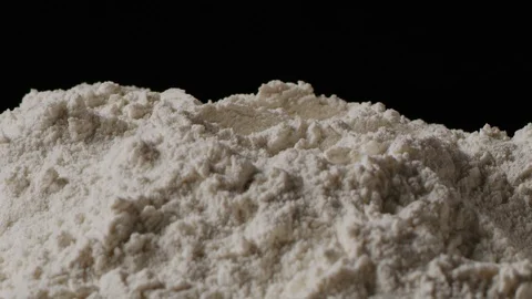 Cracking egg in flour macro shot Stock Footage 128492466