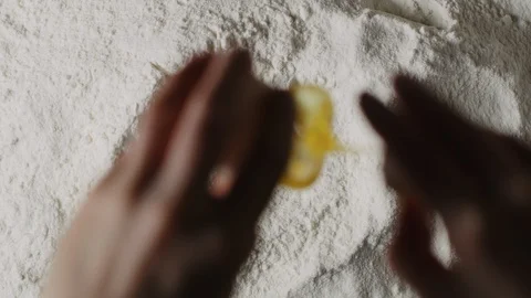 Cracking egg in flour macro shot Stock Footage 128492474