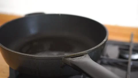 Cracking egg in hot pan for frying Stock Footage 246643758