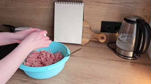 Cracking Egg into Minced Meat Bowl in Kitchen Scene Stock Footage 305750414