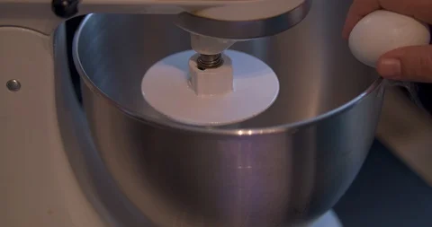 Cracking an Egg into a Mixing Bowl Stock Footage 101059143