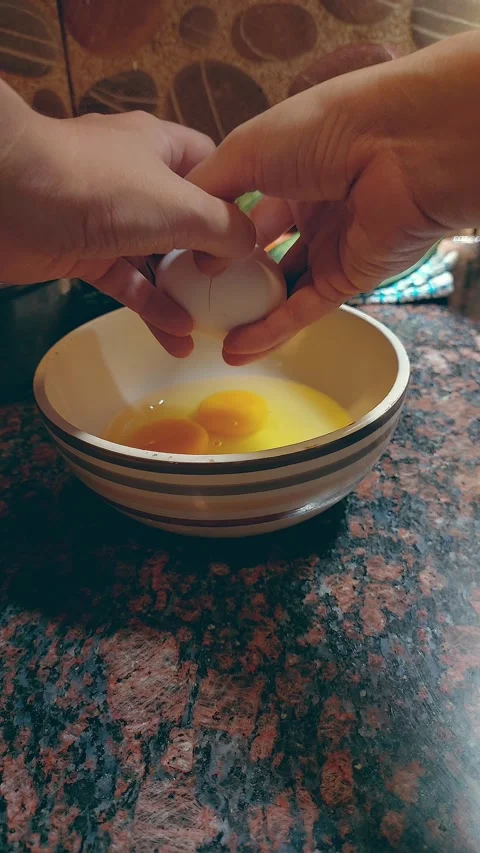 Cracking an egg open into a bowl Stock Footage 276204101