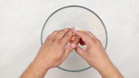 Cracking eggs and mixing them in the bowl. Stock Footage 202894345