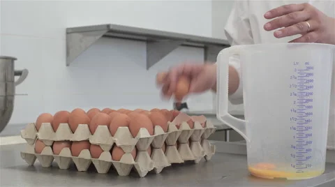 Cracking eggs in bakery. Stock Footage 68490968