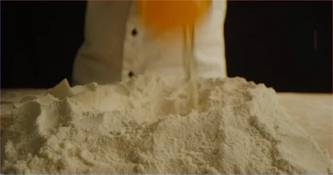 Cracking eggs in bowl macro shot Stock Footage 126299407