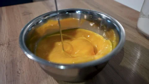 Cracking Eggs for Cooking and Preparing Delicious Dishes in a Kitchen Stock Footage 283486345