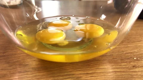Cracking Eggs into Glass Bowl – Kitchen Close-Up Stock Footage 309053589