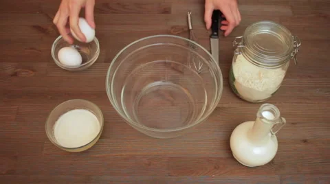 Cracking eggs on the kitchen 스톡 동영상 61919646