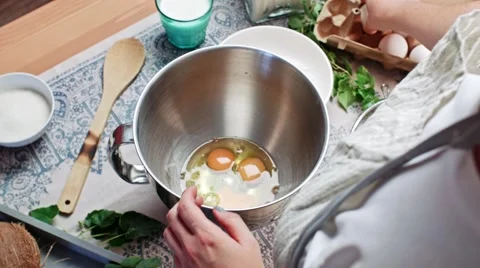 Cracking eggs, making dough Stock Footage 68164003