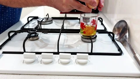 Cracking Elegance: A Golden Egg Drop into Floral Glass Beauty Stock Footage 315550515