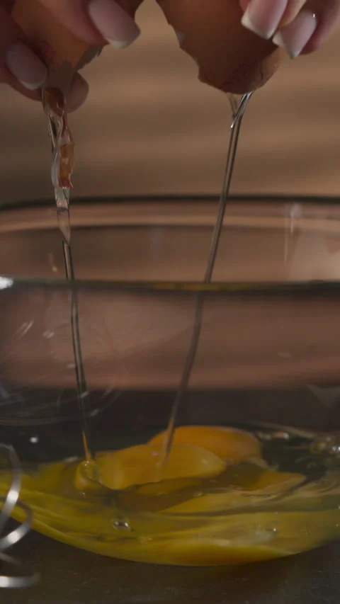 Cracking Fresh Egg Into A Bowl To Prepare Dough For Baking - Close Up, Vertical Video stock 331363645