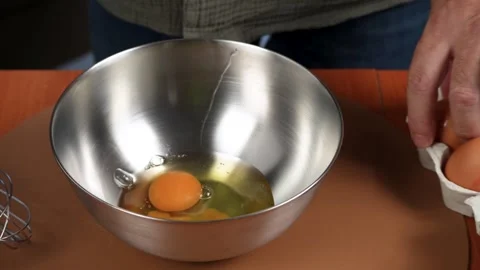 Cracking Fresh Eggs into a Metal Mixing Bowl Stock-Footage 342278762