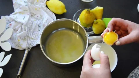 Cracking fresh eggs into saucepan for cooking 스톡 동영상 344661168