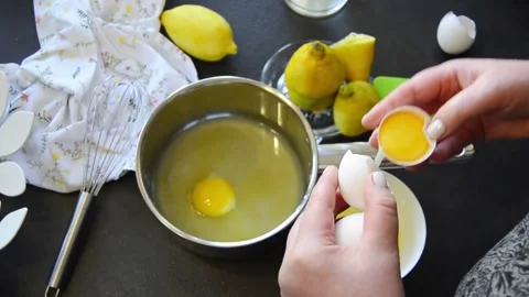 Cracking fresh eggs into saucepan for cooking 스톡 동영상 344661208