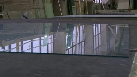 Cracking glass by worker hands on cutting table, window glass manufacturing Stock Footage 82402231