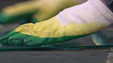 Cracking glass by worker hands on cutting table, window glass manufacturing Video stock 82402242