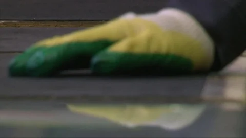 Cracking glass by worker hands on cutting table, window glass manufacturing Video stock 82402252