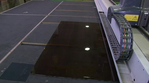 Cracking glass by worker hands on cutting table, window glass manufacturing Video stock 82402275