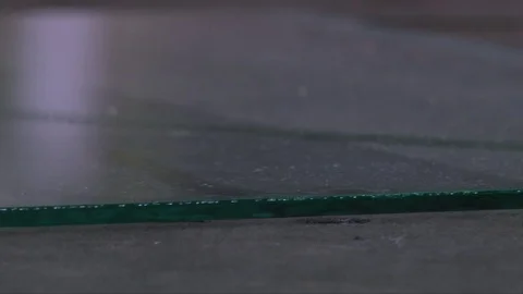 Cracking glass by worker hands on cutting table, window glass manufacturing Stock-Footage 82402359