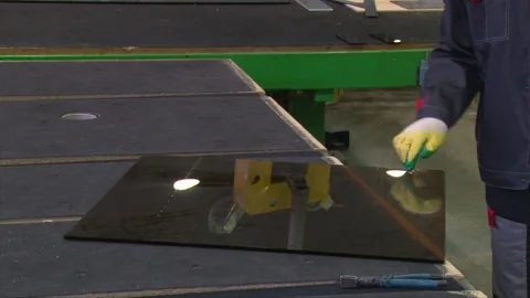 Cracking glass by worker hands on cutting table, window glass manufacturing Video stock 82402402