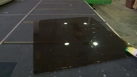 Cracking glass by worker hands on cutting table, window glass manufacturing Video stock 82402445