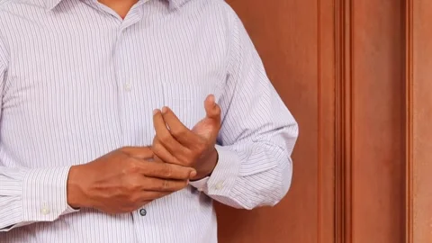 Cracking his finger knuckles or joints for a sense of relief Stock Footage 345702877