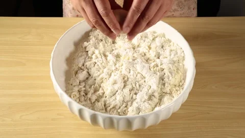Cracking Raw Egg into White Flour Bowl Close Up Slow Motion Stock Footage 339560353