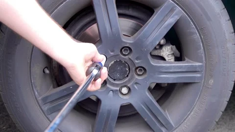Cracking a tight wheel bolt Stock Footage 157060923