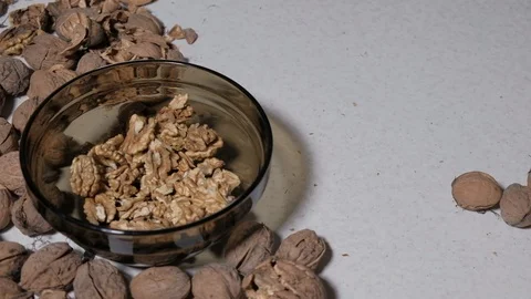 Cracking a walnuts at home. Hammer to break nuts. Collects a nuts in glass bowl Stock Footage 129086149