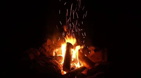 Crackling campfire in stone ring with sparks and audio Stock Footage 55731054