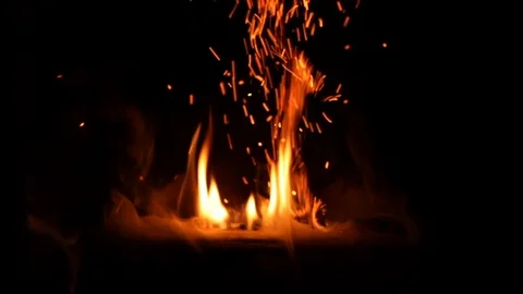 Crackling fire place slow motion with large pop and flying embers Video stock 111540557