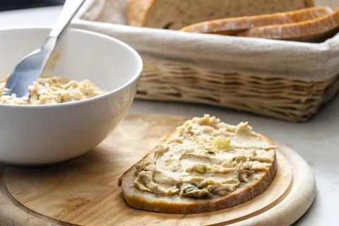Cracklings spread with pickled cucumber on slice of bread Stock Photos