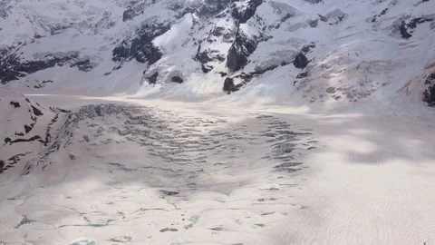 Cracks and blocks of ice on the glacier high in the mountains Stock Footage 235238179