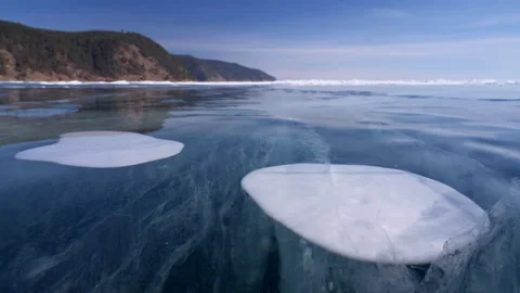 Cracks and bubbles inside ice on frozen Baikal lake, dolly slideways motion Stock Footage 180331038